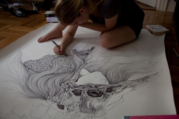 Caitlin Hackett drawing in her studio